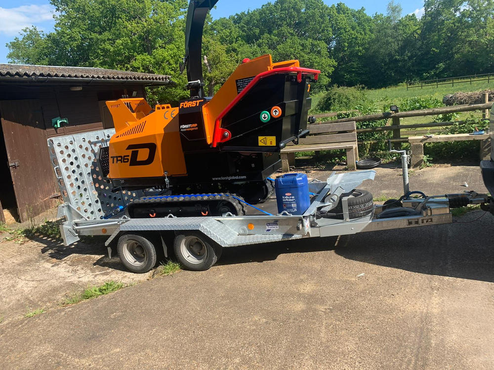 A Forst TR6D tracked woodchipper loaded on a plant trailer