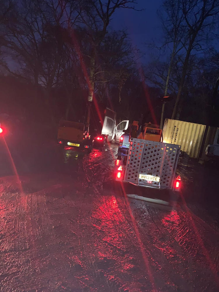 ADF vehicles lined up with hazard lights on during a night callout