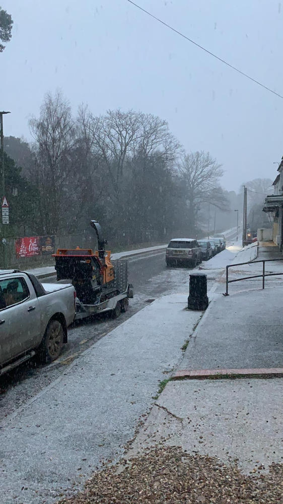 An ADF pickup and chipper on a village high street during heavy snow